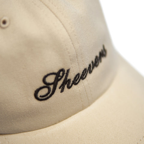 beige cap with brown embroidery