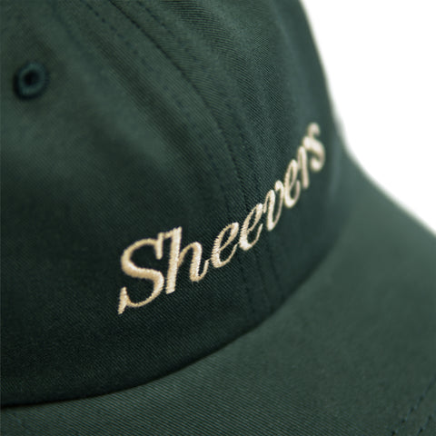 green cap with beige embroidery